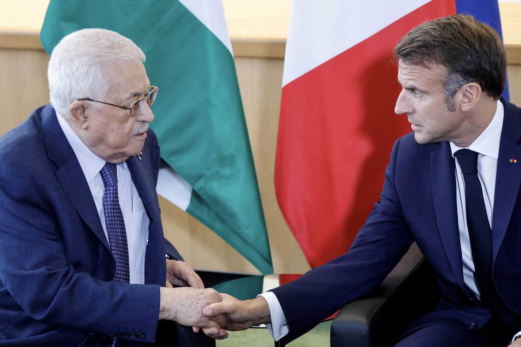 (FILES) French President Emmanuel Macron (R) shakes hands with Palestinian President Mahmud Abbas during a meeting on the sidelines of the 79th Session of the United Nations General Assembly in New York on September 25, 2024. French President said on July 24, 2025 his country would formally recognise a Palestinian state during a UN meeting in September, the most powerful European nation to announce such a move. (Photo by Ludovic MARIN / AFP)